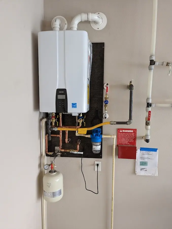 Professional plumber installing copper piping in a Bethany home